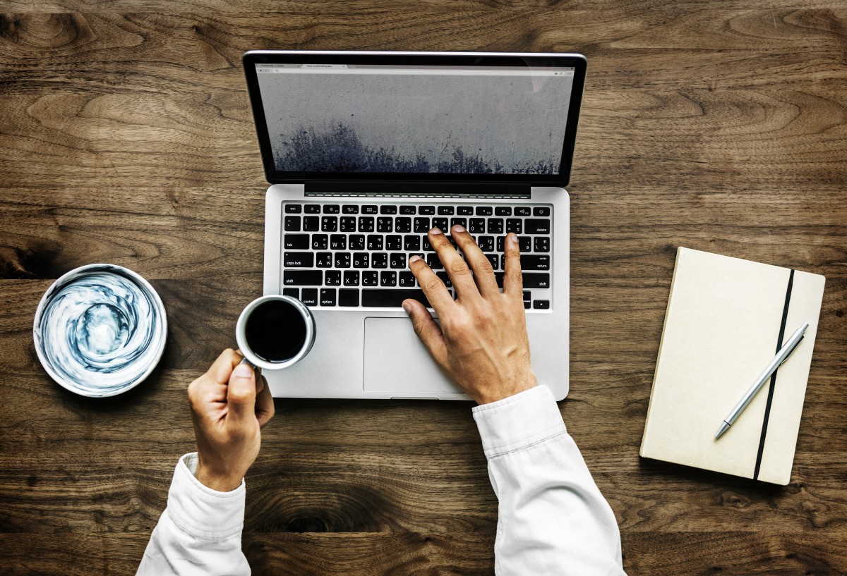 Man with laptop and coffee